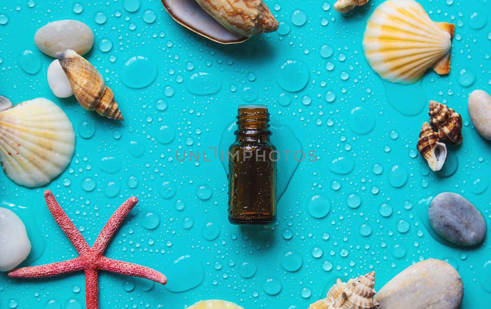 Essential oil on sea background. Selective focus. by yanadjana