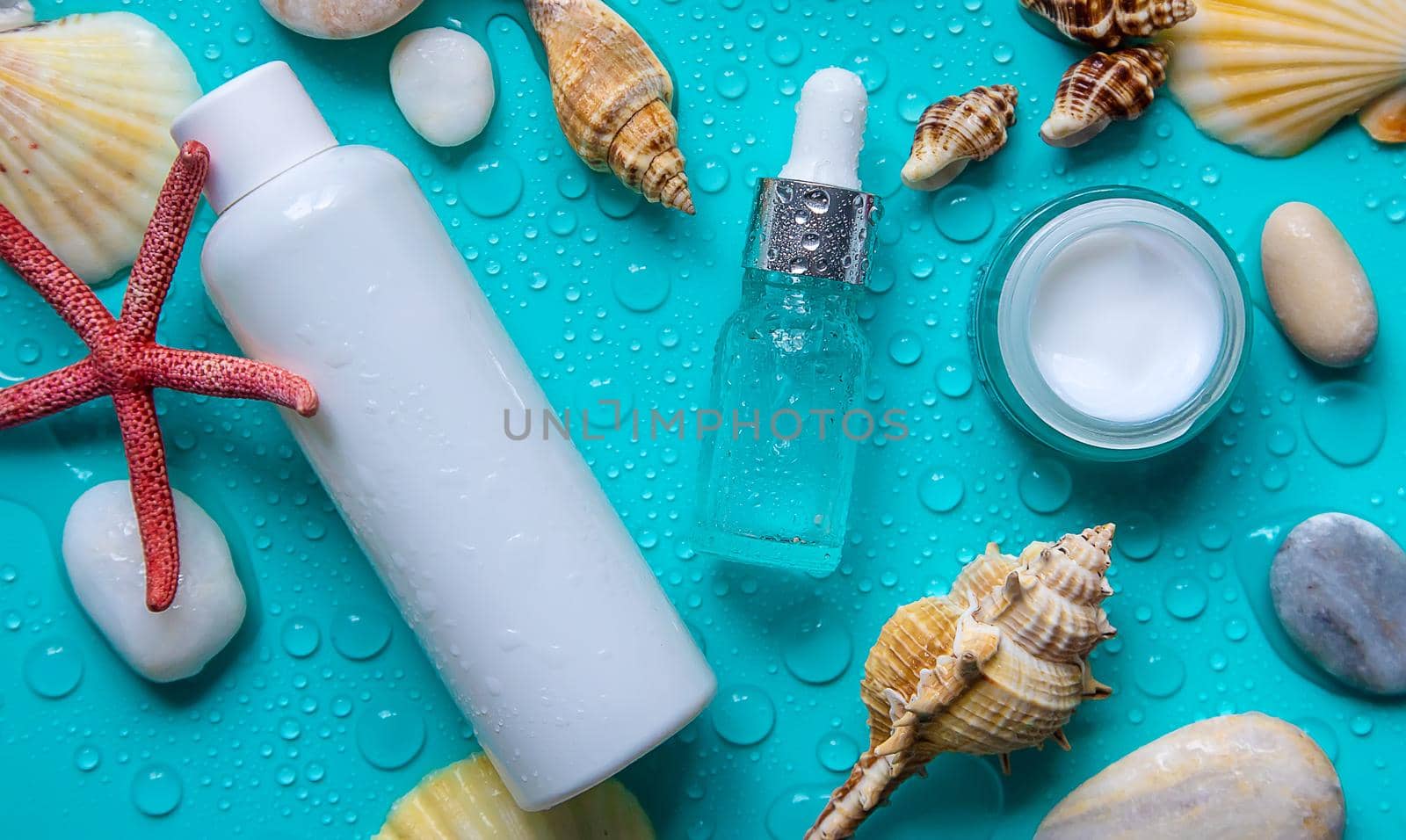 Moisturizing lotion cream on a sea background. Selective focus. by yanadjana