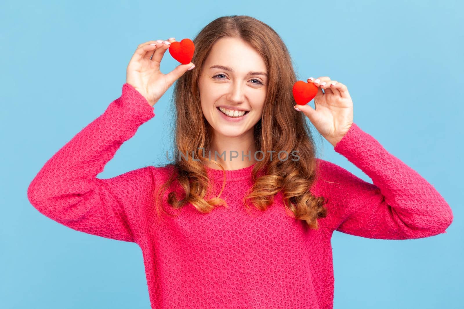 Woman having fun with red toy hearts, showing his fondness and devotion, romance. by Khosro1
