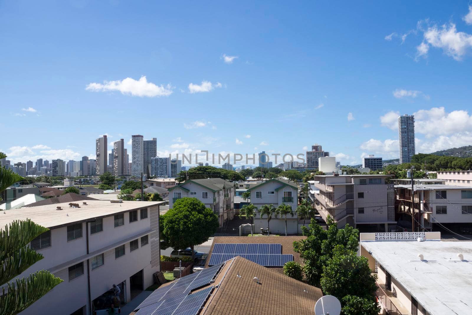 Kapahulu town in Honolulu with homes, condos, and mountain of Tantalus on a clear day on Oahu, Hawaii.