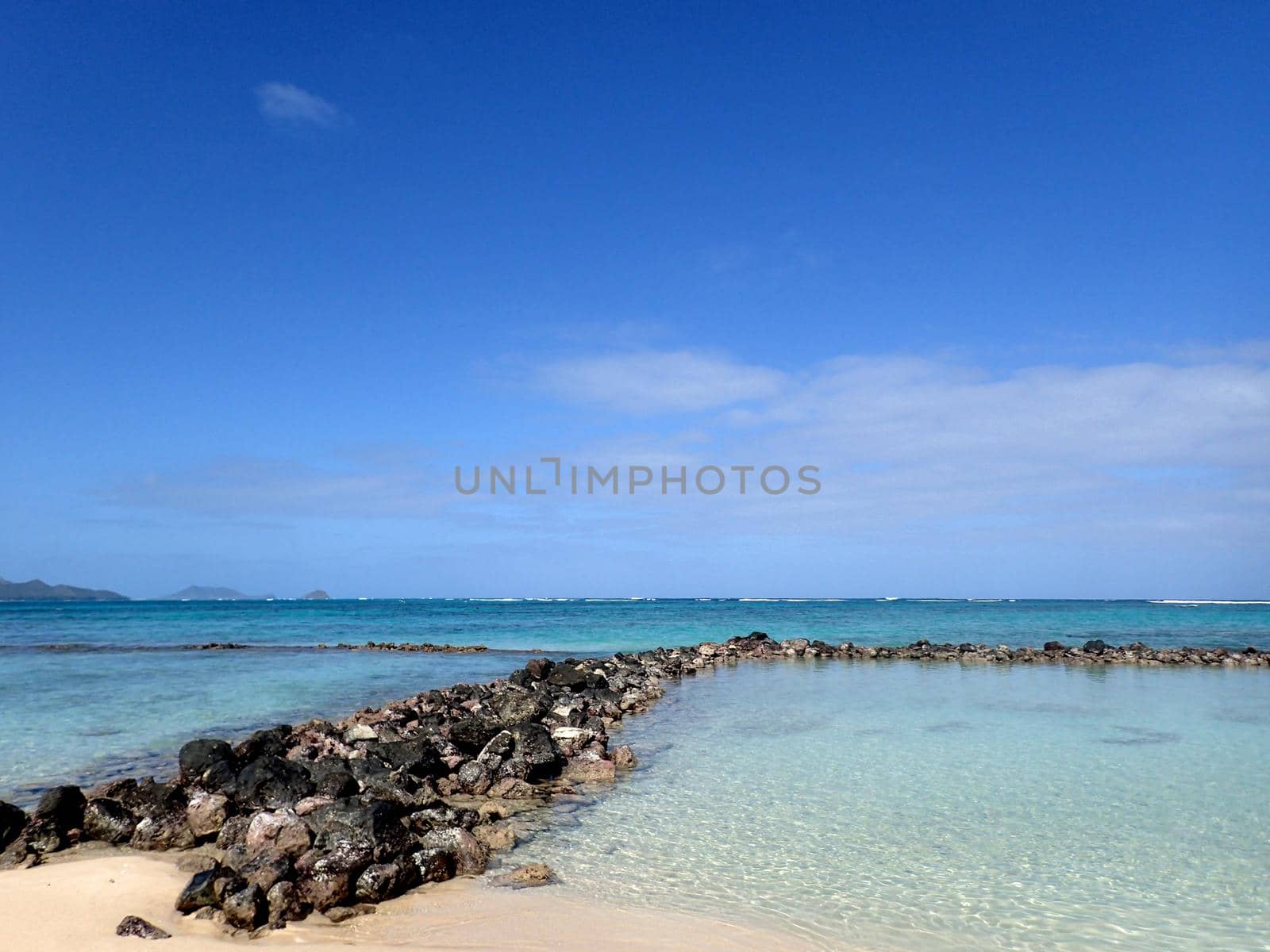 Rocks going into the water form the Pahonu Pond by EricGBVD