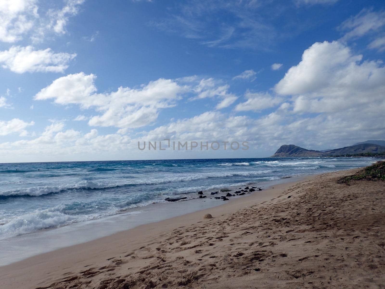 Waves break along the shore of Manners Beach on the western coast of Oahu, Hawaii. 