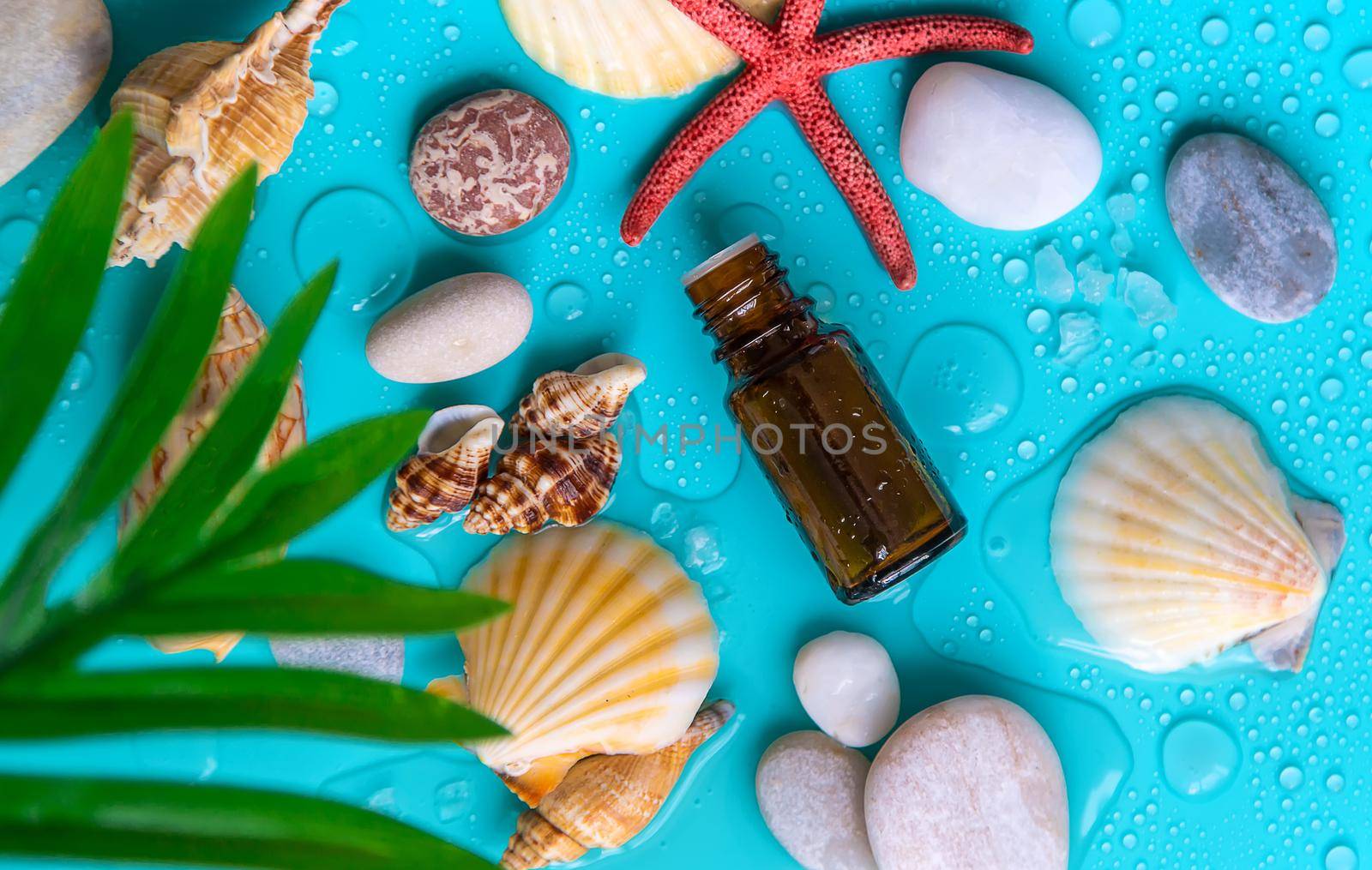 Essential oil on sea background. Selective focus. Spa.