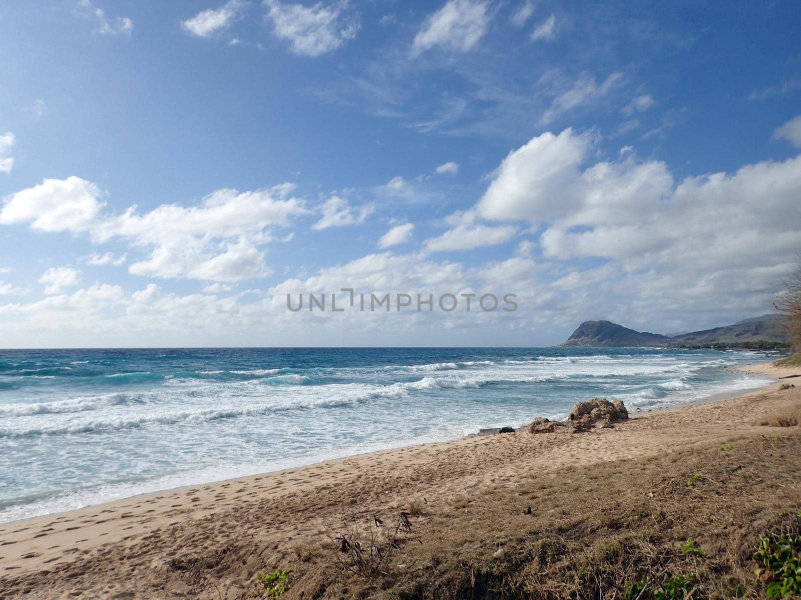 Waves break along the shore of Manners Beach on the western coast of Oahu, Hawaii. 