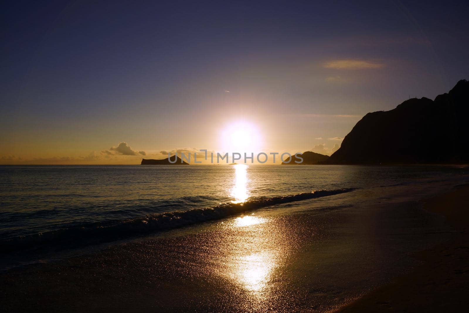 Early Morning Sunrise on Waimanalo Beach on Oahu, Hawaii over Rock Island bursting through the clouds. 2013.