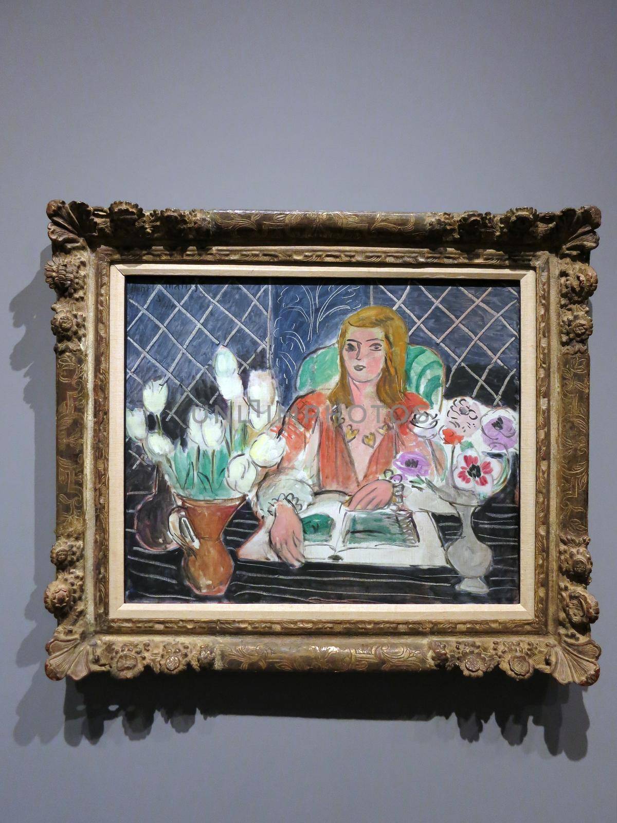 Annelies, White Tulips and Anemones - painting by Henri Matisse from 1944.

The painting depicts a woman smiling at a table with flowers aligned on it. The painting is currently in the Honolulu Museum of Art.
