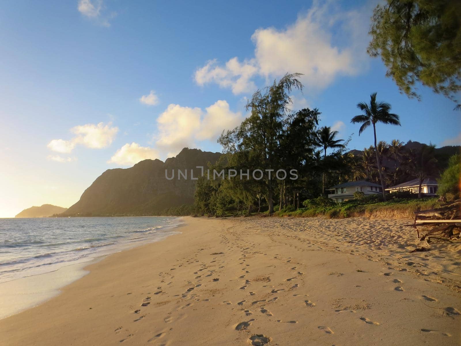 Gentle wave lap on Waimanalo Beach in the early morning light on a nice day Oahu, Hawaii.