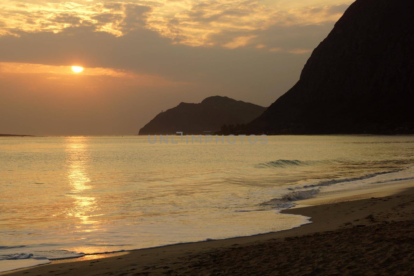 Early Morning Sunrise on Waimanalo bay going into the clouds and beach by EricGBVD