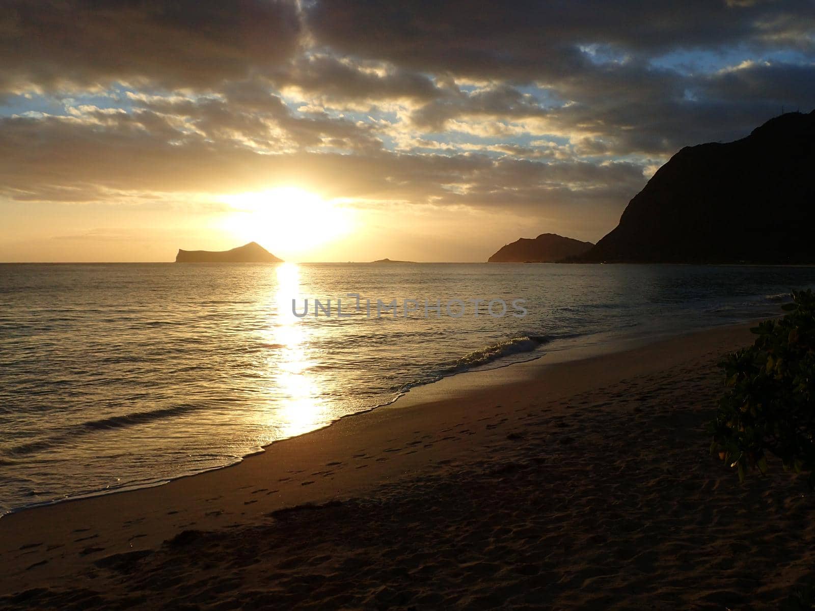 Early Morning Sunrise on Waimanalo Beach over Rabbit Island bursting through the clouds by EricGBVD