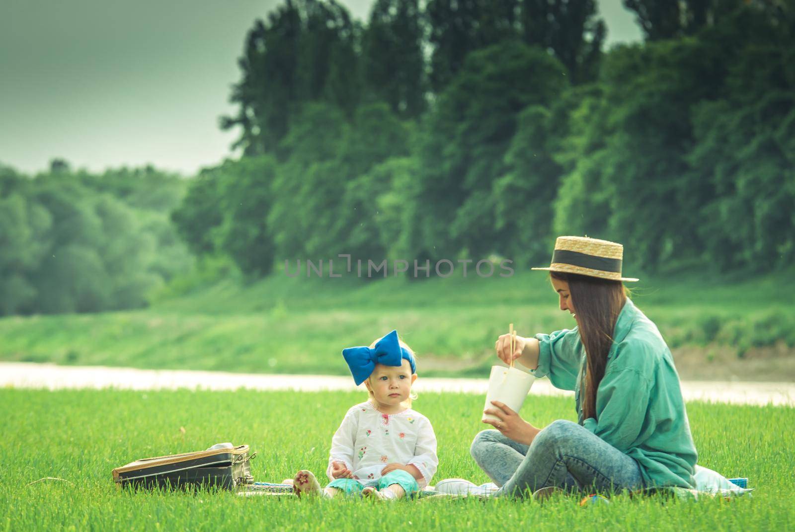 Mother is playing with baby girl in the park. High quality photo