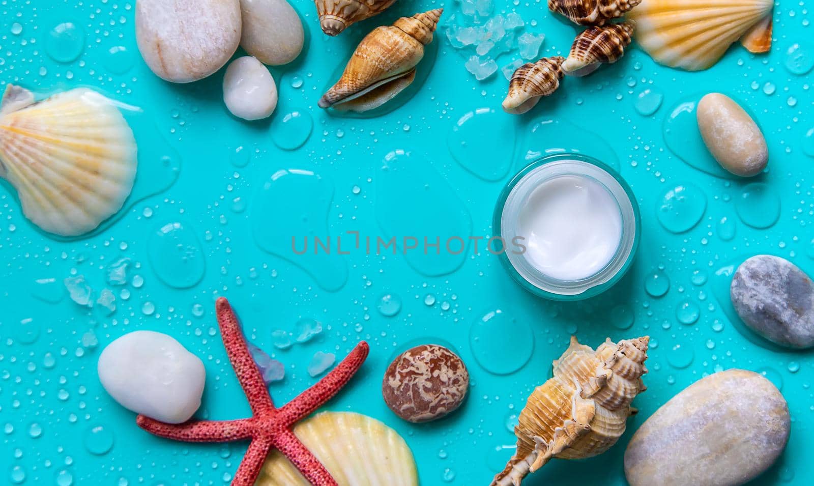 Moisturizing lotion cream on a sea background. Selective focus. by yanadjana