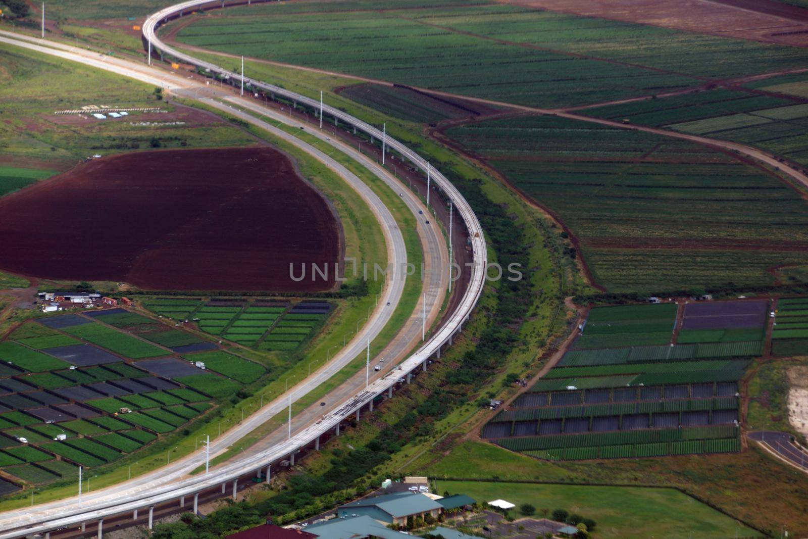 Aerial HART Rail system under construction and Highway next to each other in Kapolei city on Oahu, Hawaii.