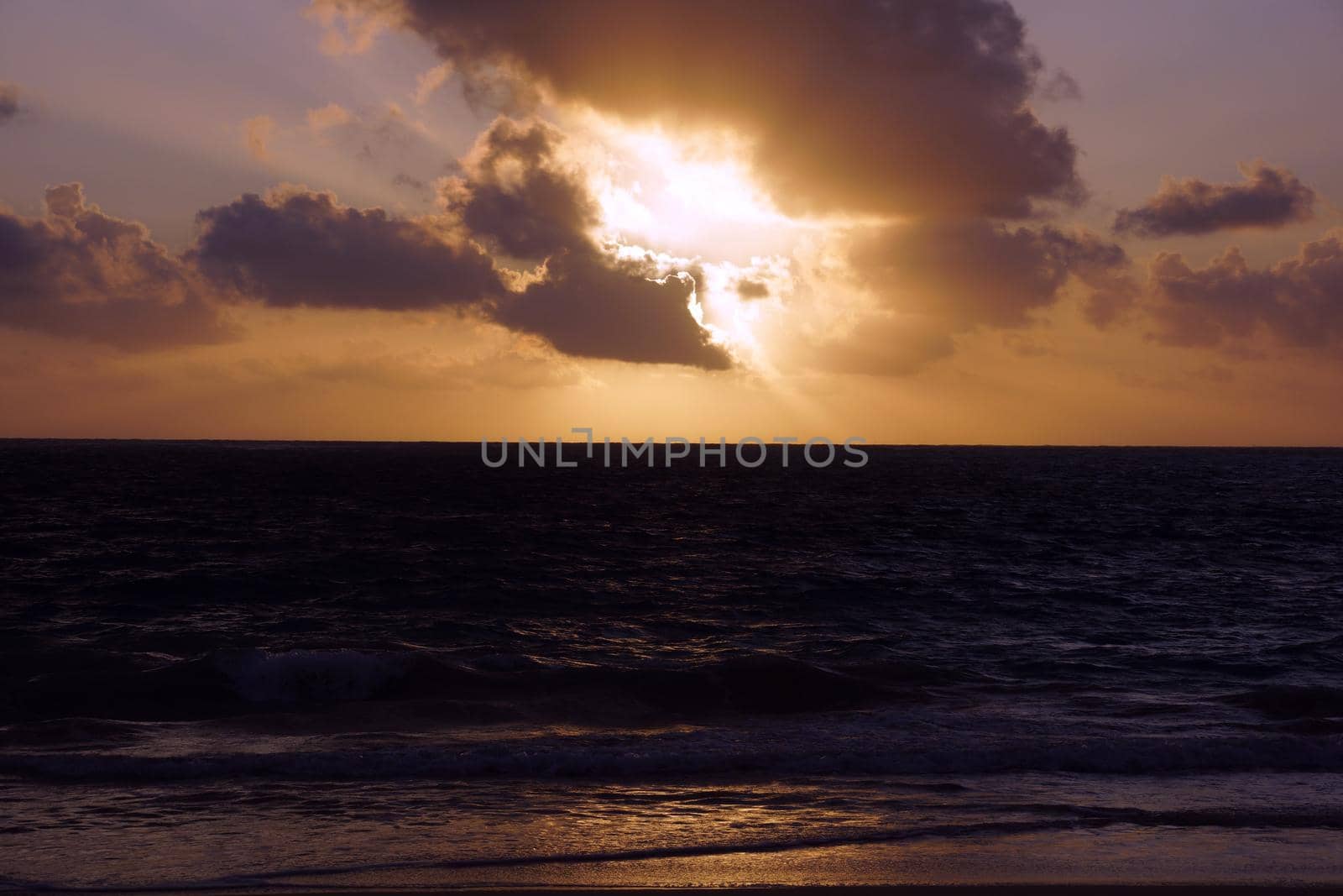 Early Morning Sunrise on Waimanalo Beach over ocean bursting through the clouds by EricGBVD