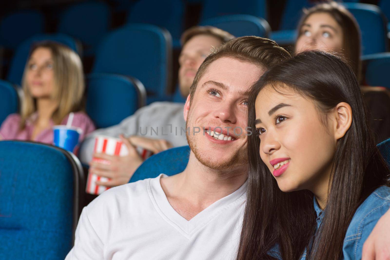 Favorite kind of a date. Closeup shot of a happy young couple enjoying movies together at the local movie theatre