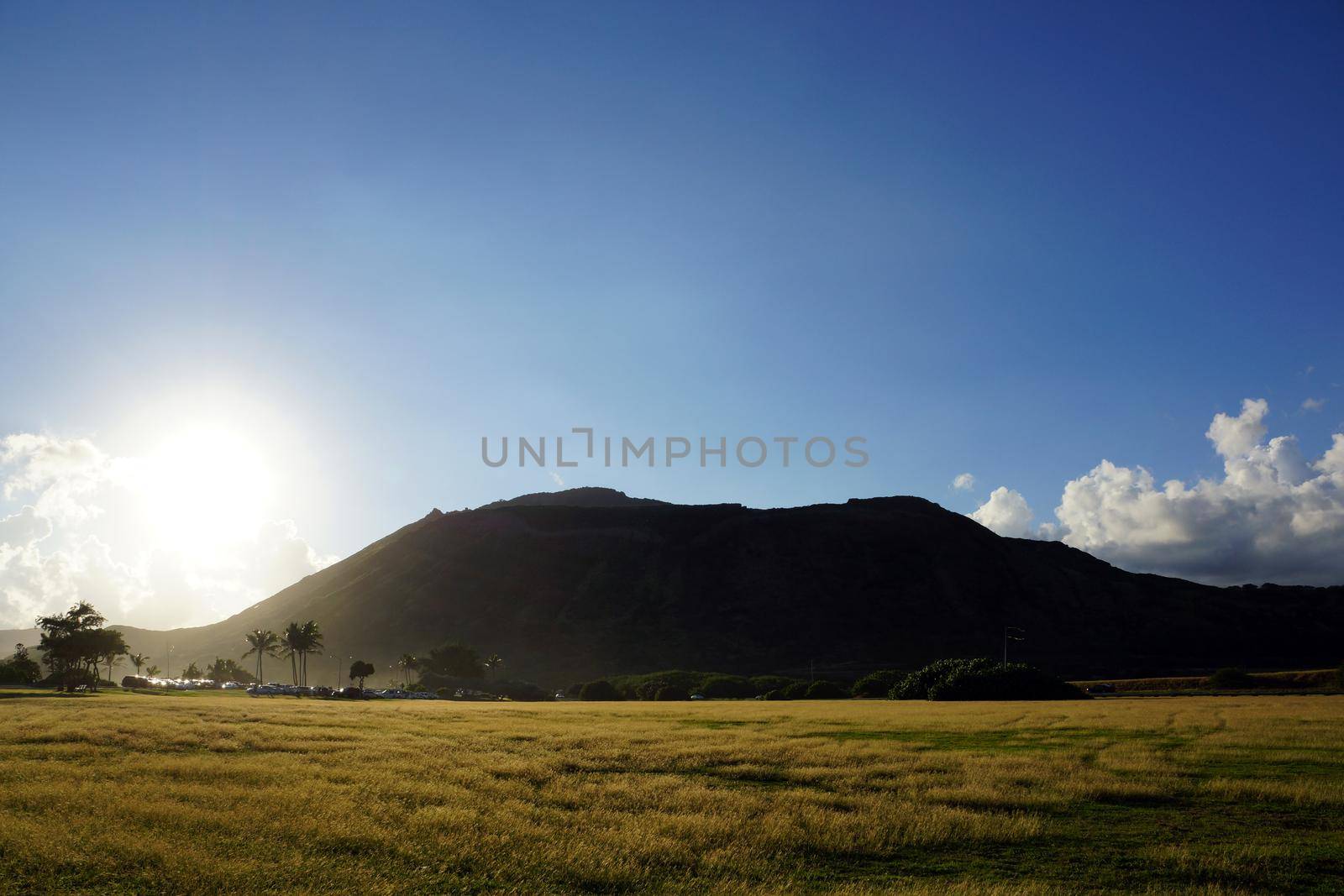 Sunset over Sandy Beach Park grass field and Koko Head Crater by EricGBVD