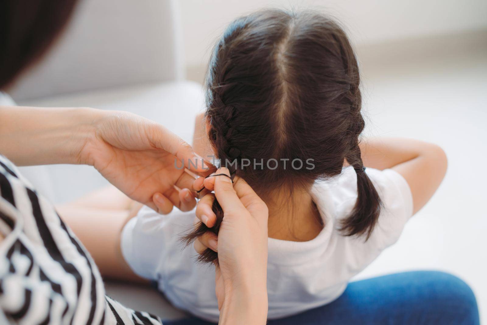 Hand making braid for little girl