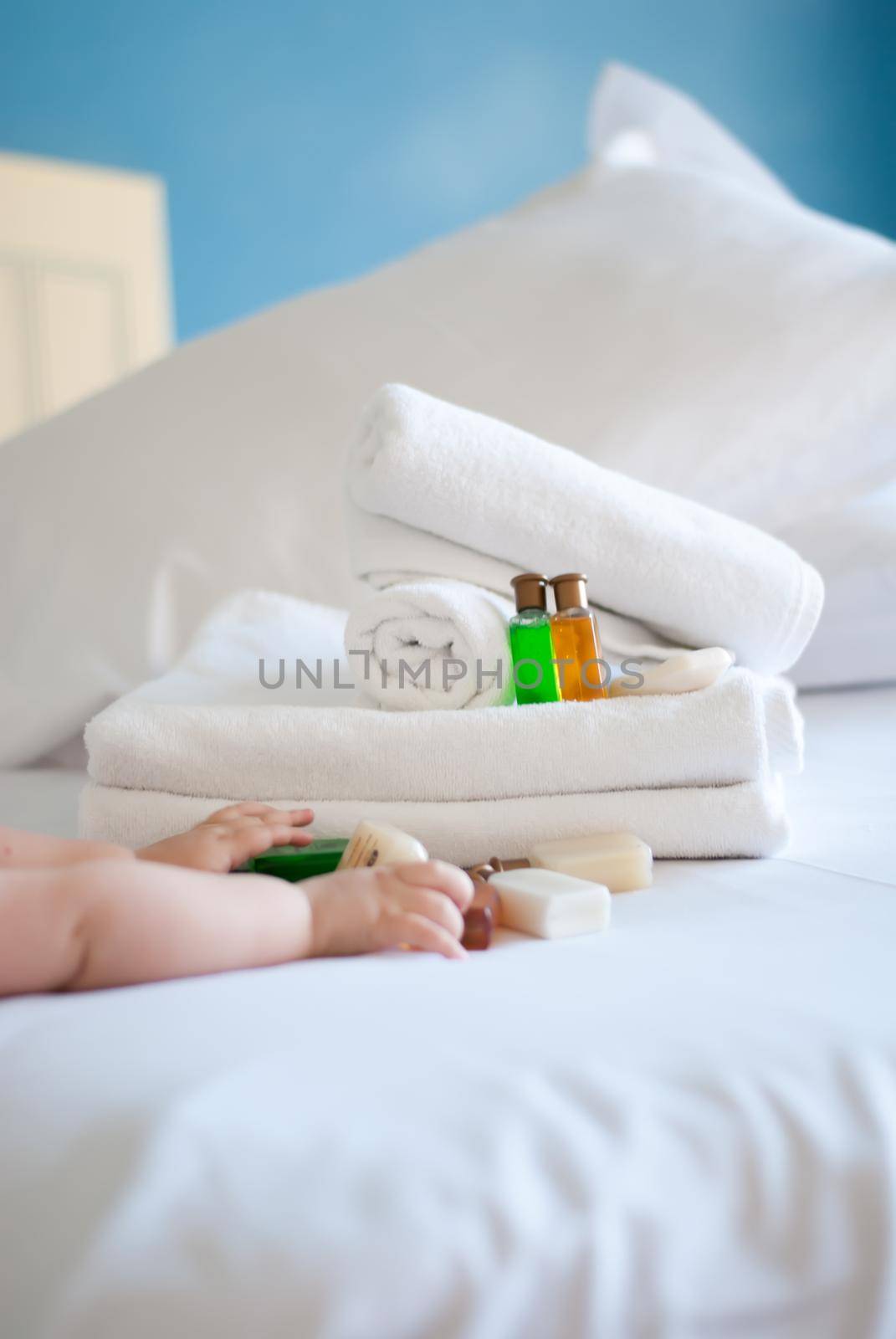 white pure towels on bed in the hotel with soap and shower gel