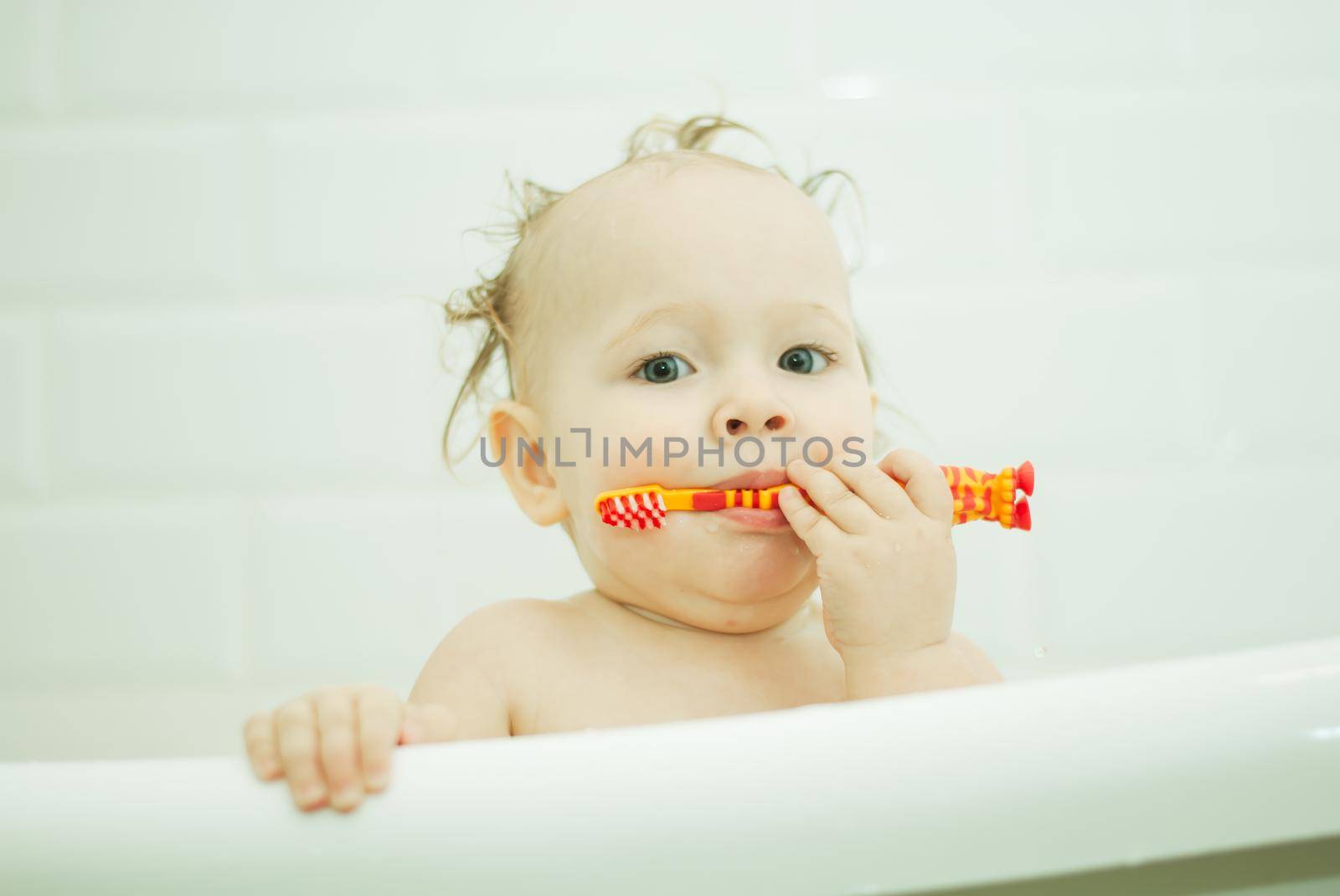 cute babygirl in bathroom baby learning to clean teeth with toothbrush