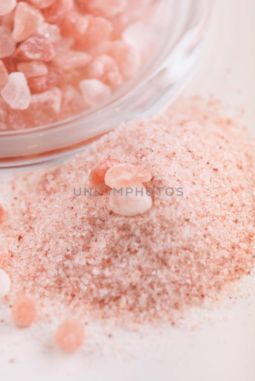 crystals of pink healthy himalayan salt in glass plate