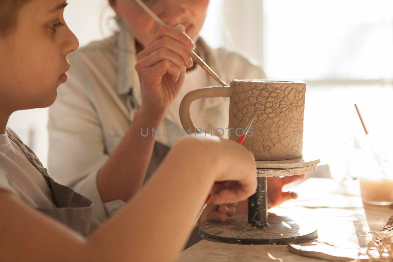 Mother and Son Making Pottery together by MAD_Production