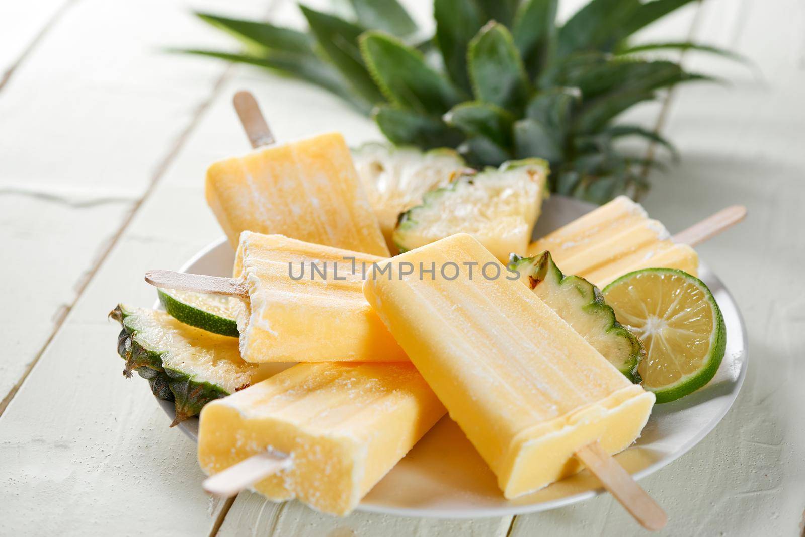 Homemade ice cream or popsicles from pineapple. Frozen fruit pulp. Summer sweets.