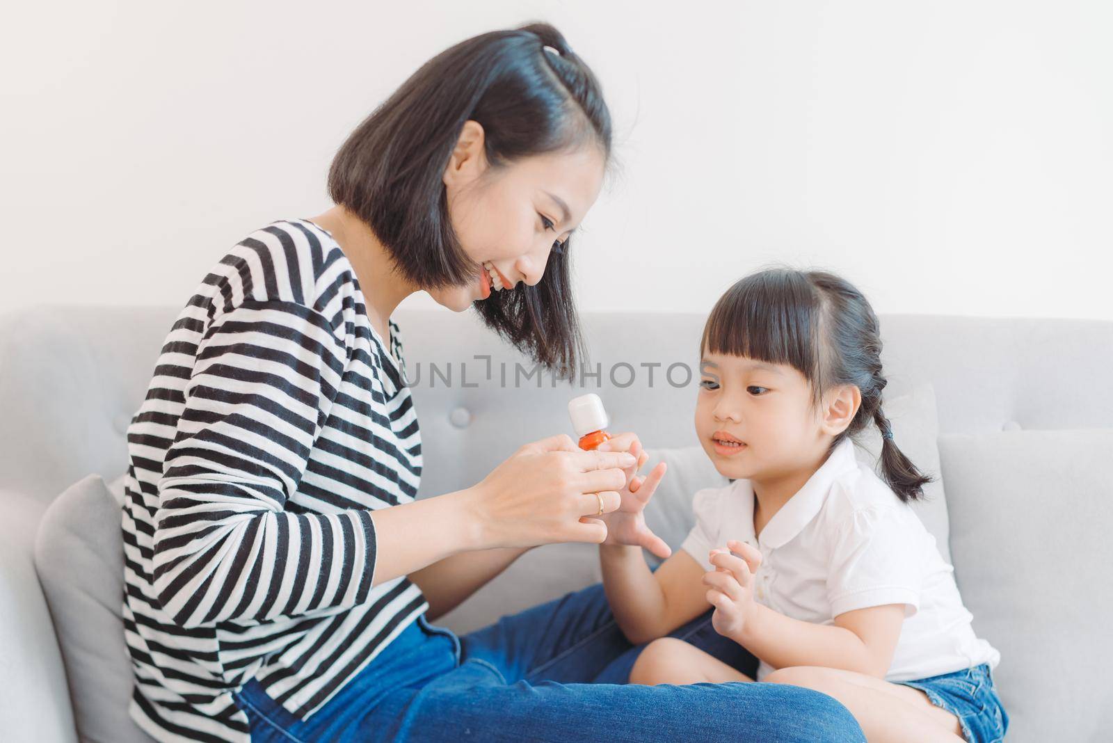 Mom paints nails to daughter