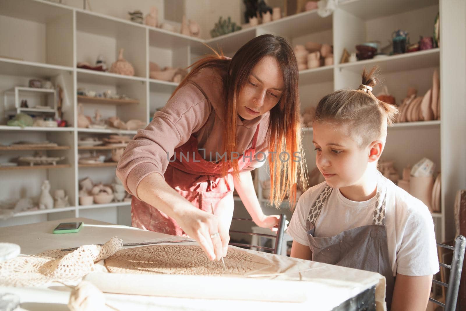 Professional Potter teaching young boy by MAD_Production