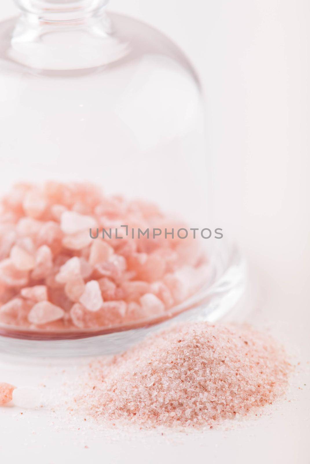 crystals of pink healthy himalayan salt in glass plate