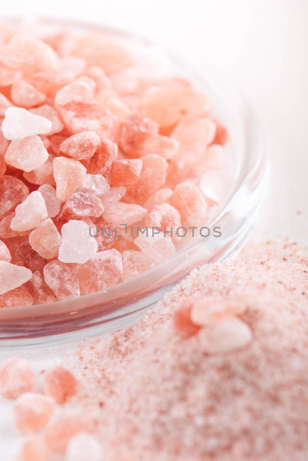 crystals of pink healthy himalayan salt in glass plate
