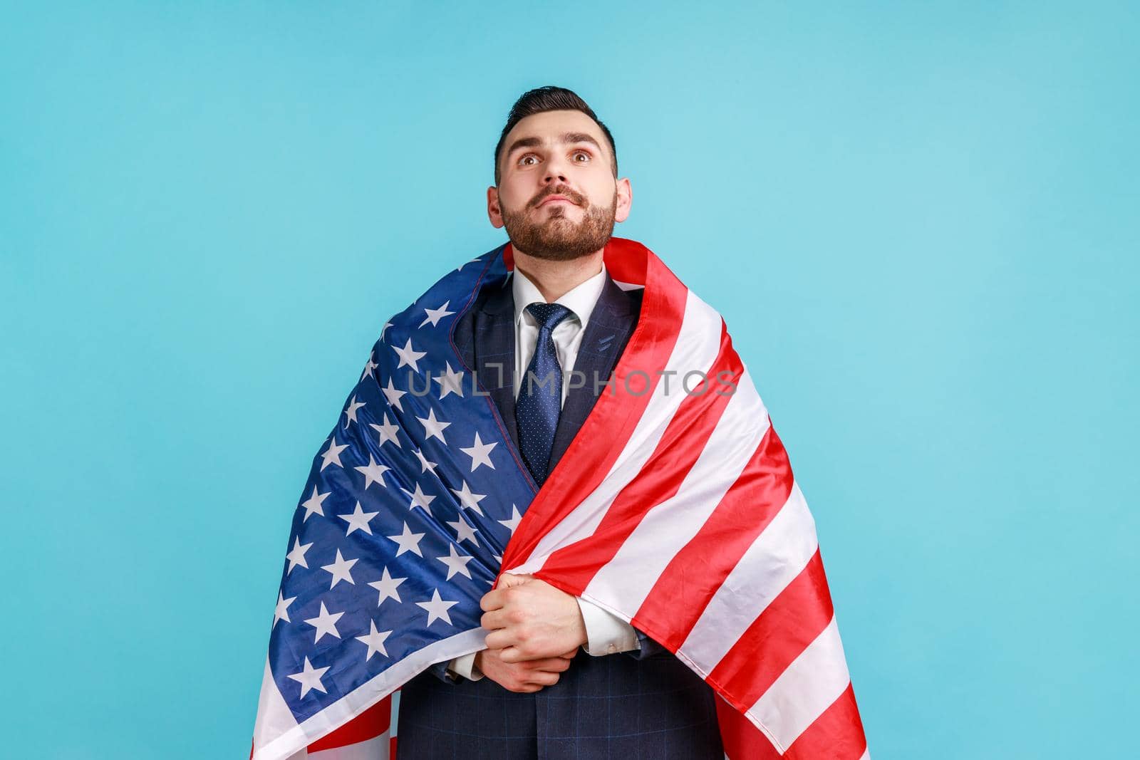 Young adult bearded businessman being wrapped in USA flag, celebrating labor day or US Independence day 4th of july, government employment support. by Khosro1