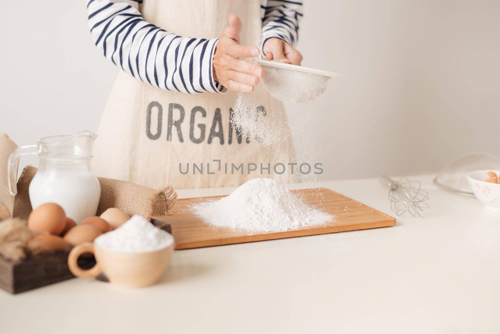 Flour sifting through a sieve for a baking