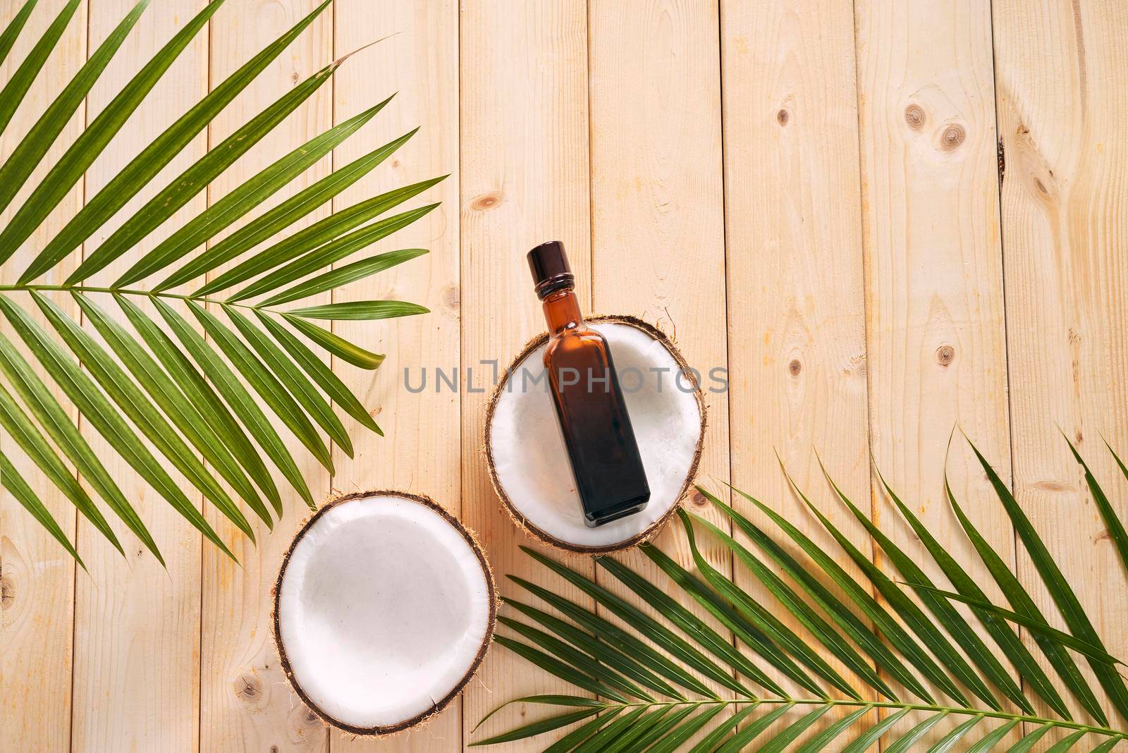 coconuts and coconut oil on wooden background.