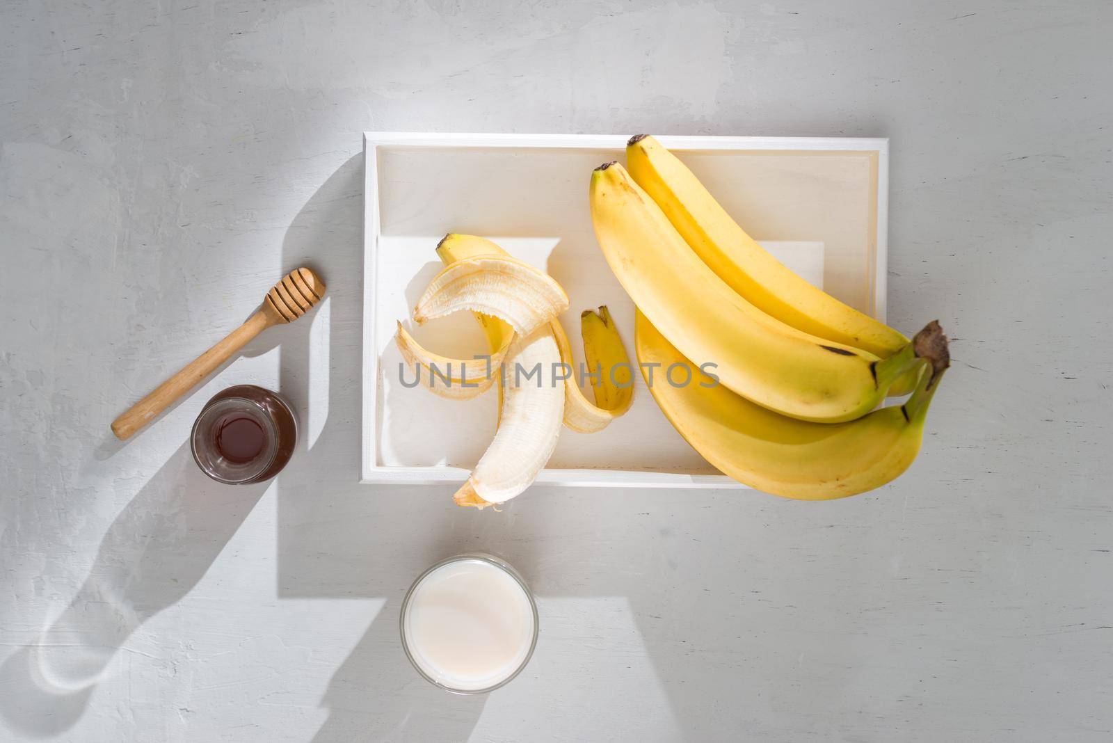 a sliced banana in a bowl on wooden background