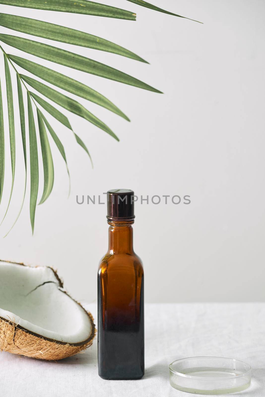 Spa cosmetics in brown glass bottles on gray concrete table. Copy space. Beauty blogger, salon therapy, minimalism concept
