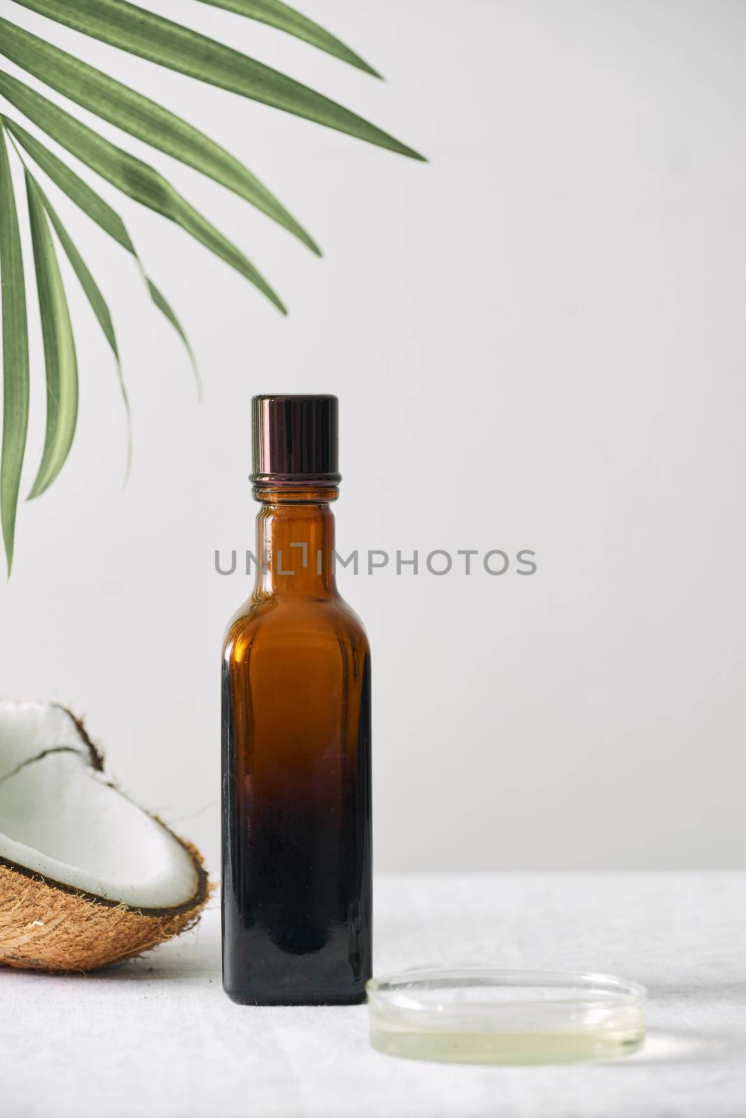 Spa cosmetics in brown glass bottles on gray concrete table. Copy space. Beauty blogger, salon therapy, minimalism concept by makidotvn