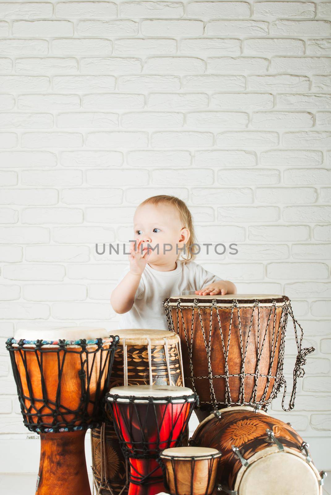 Cute baby playing drums by maramorosz