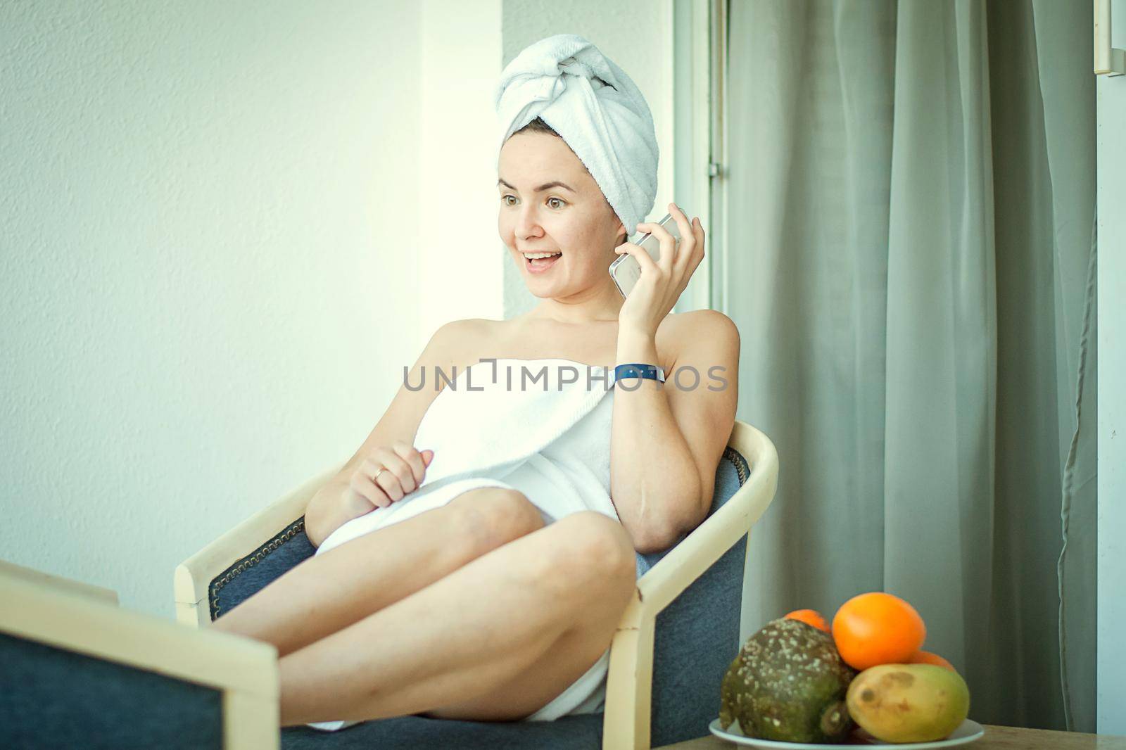 young woman in the hotel talking mobile phone by maramorosz
