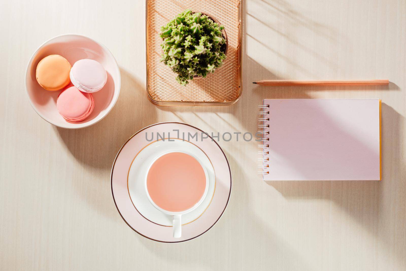 Styled stock photography beige office desk table with blank notebook, macaroon, supplies and coffee cup