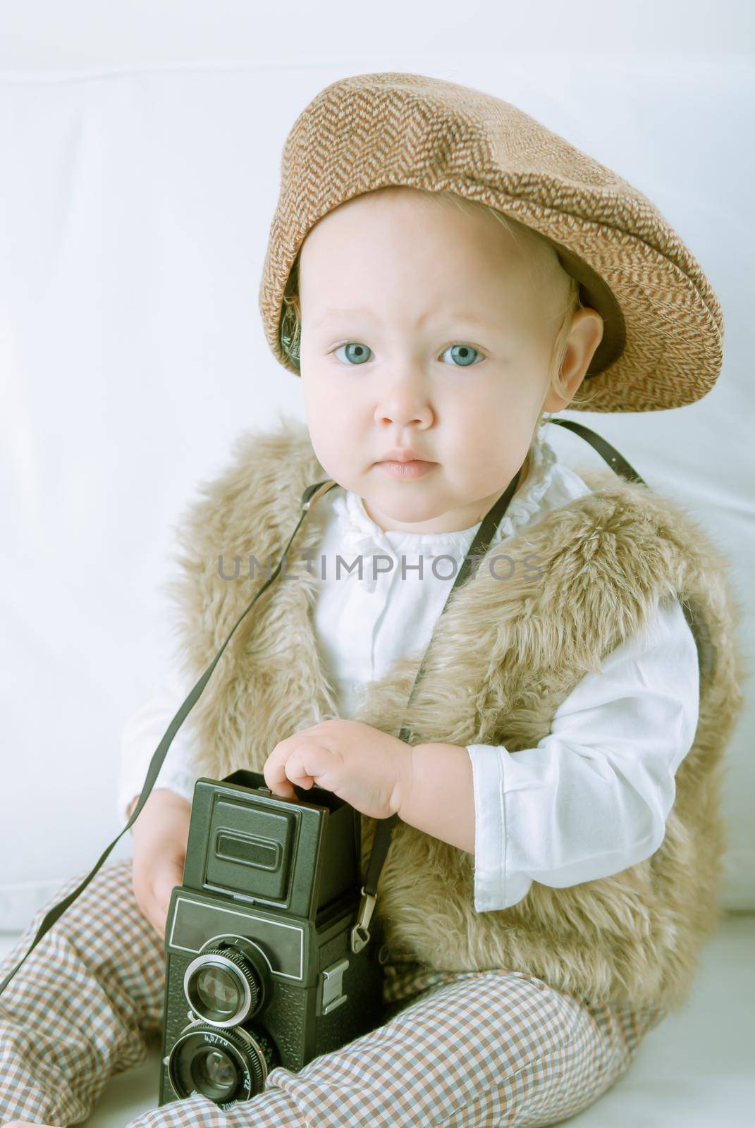 Cute baby with retro camera. High quality photo