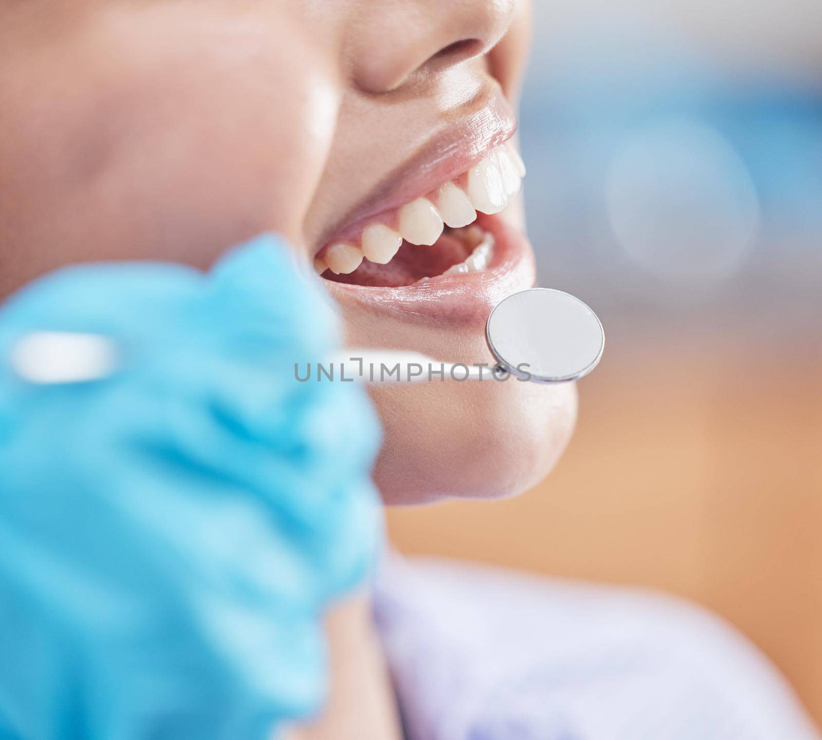 a woman about to have her teeth checked by the dentist.