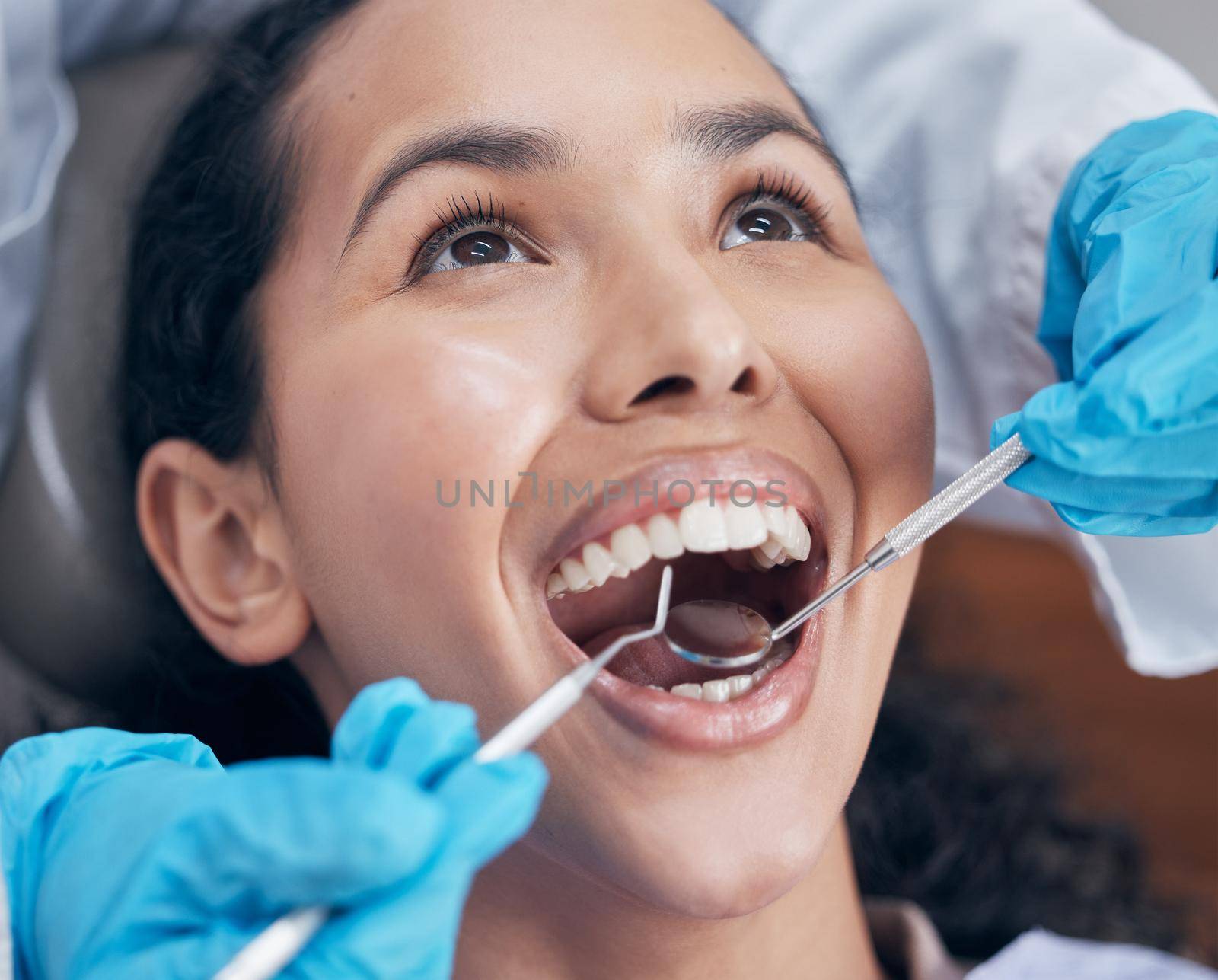 a dentist checking a young patients progress.