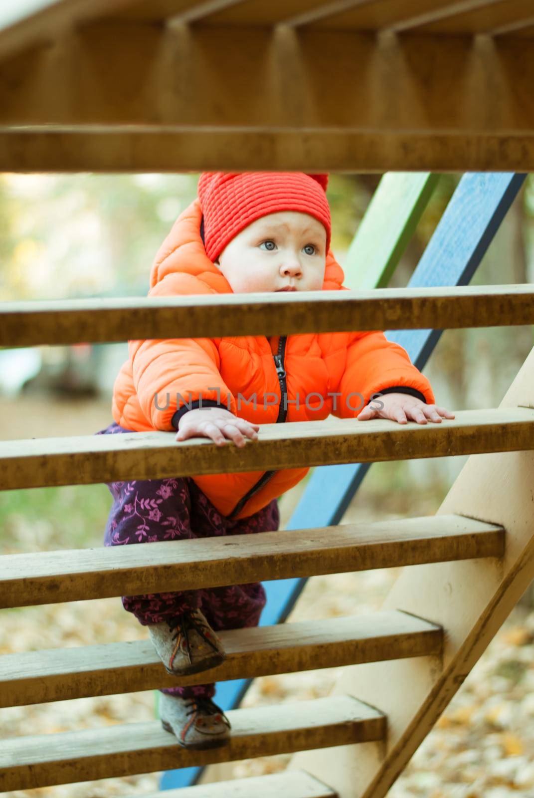 the child climbs the steps on the playground. High quality photo