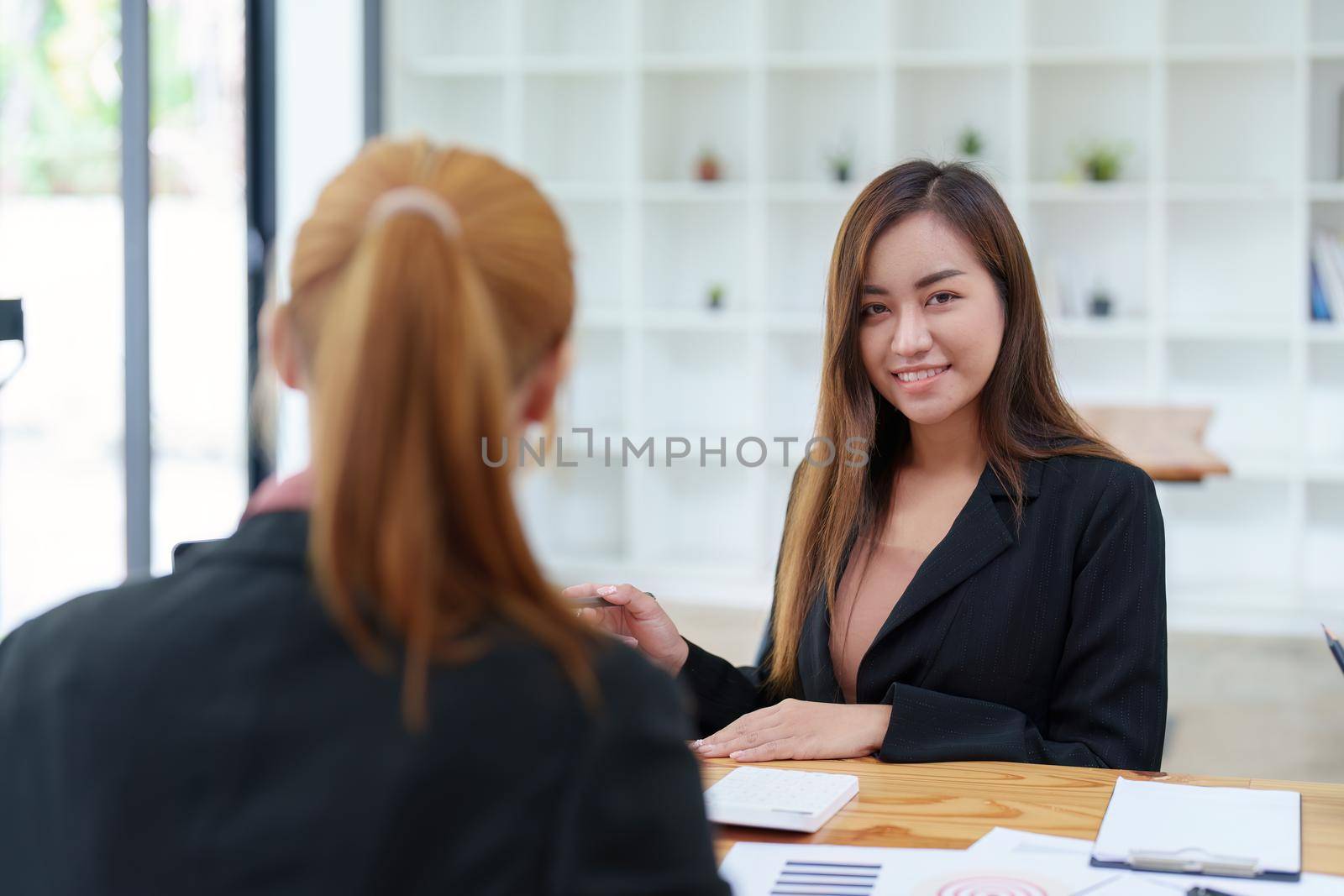 Portrait of an Asian businesswoman consulting, start up a marketing plan to meet the needs of customers in office room