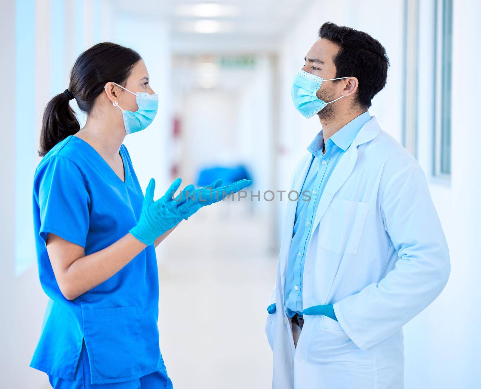 a young dentist speaking to his assistant.