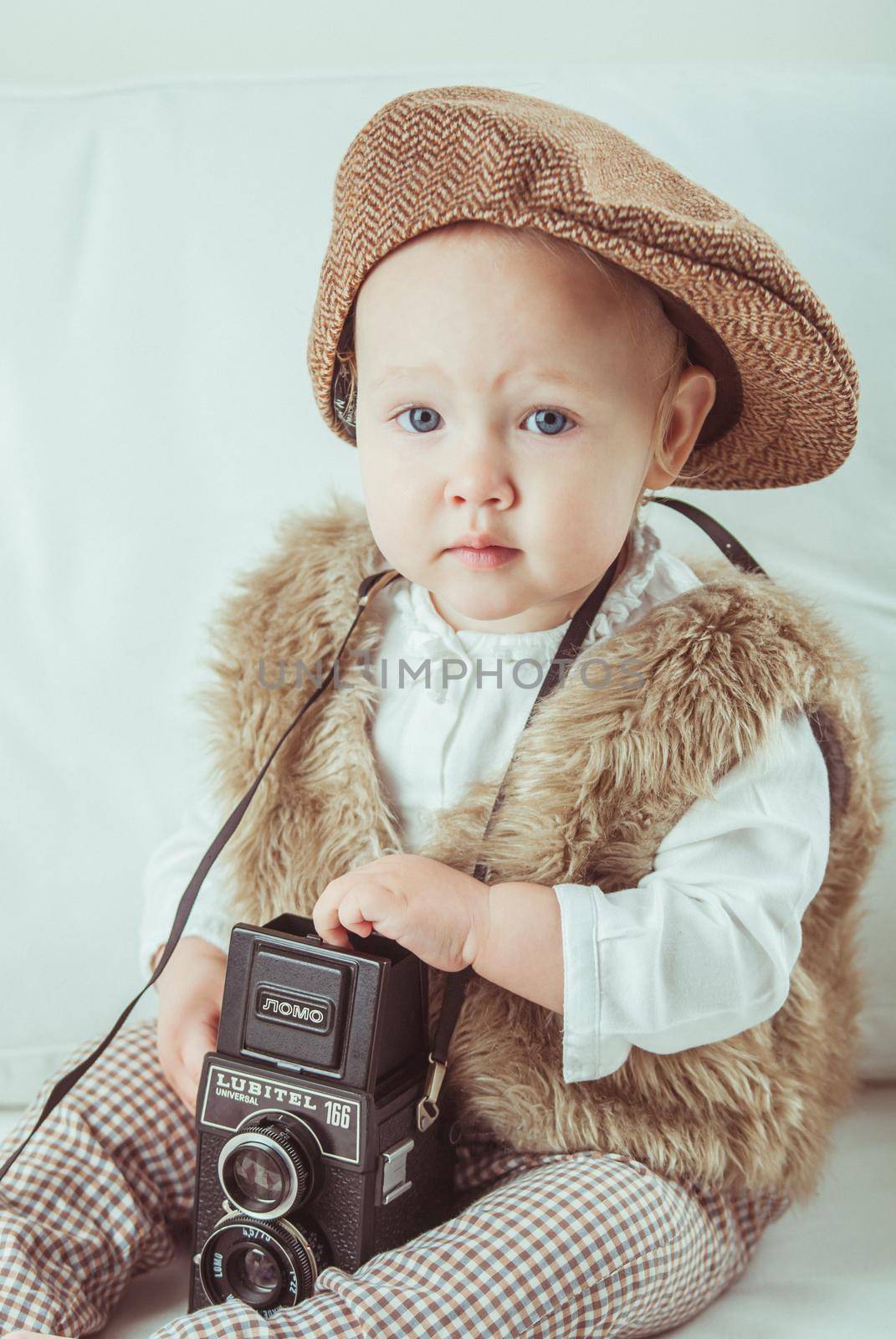 Cute baby with retro camera. High quality photo