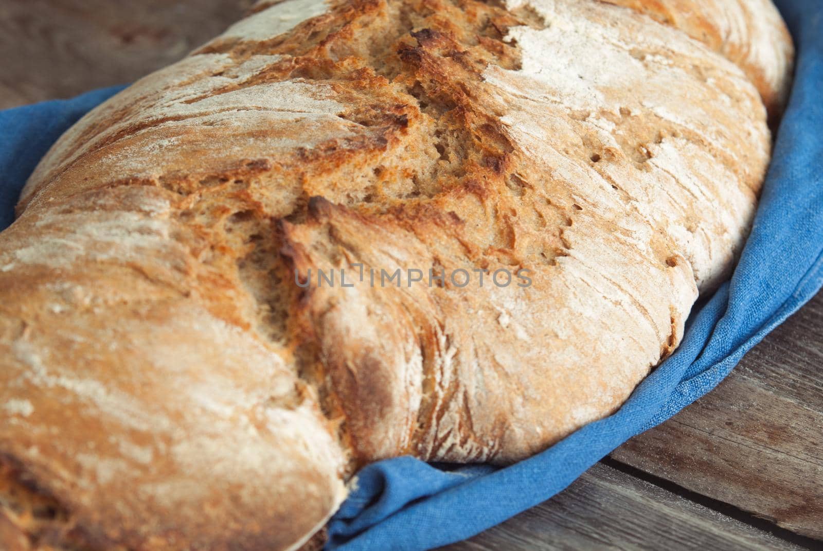 wholegrain fresh homamade bread on wooden roostick background