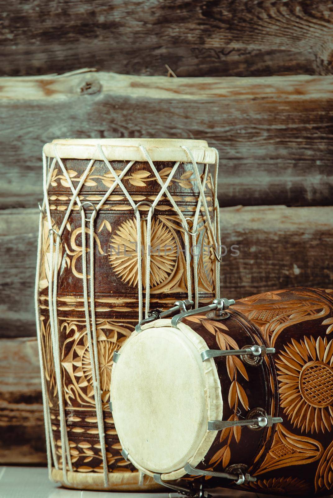variation of beautiful ethnic indian drums dholak on wooden background