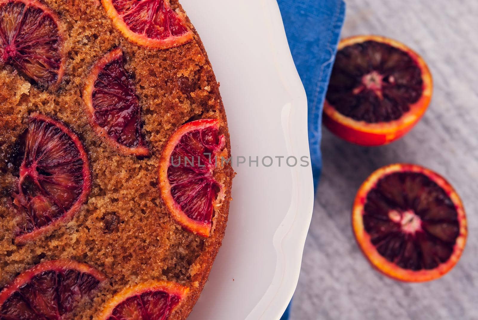 delicious cake with red oranges slices on top. High quality photo