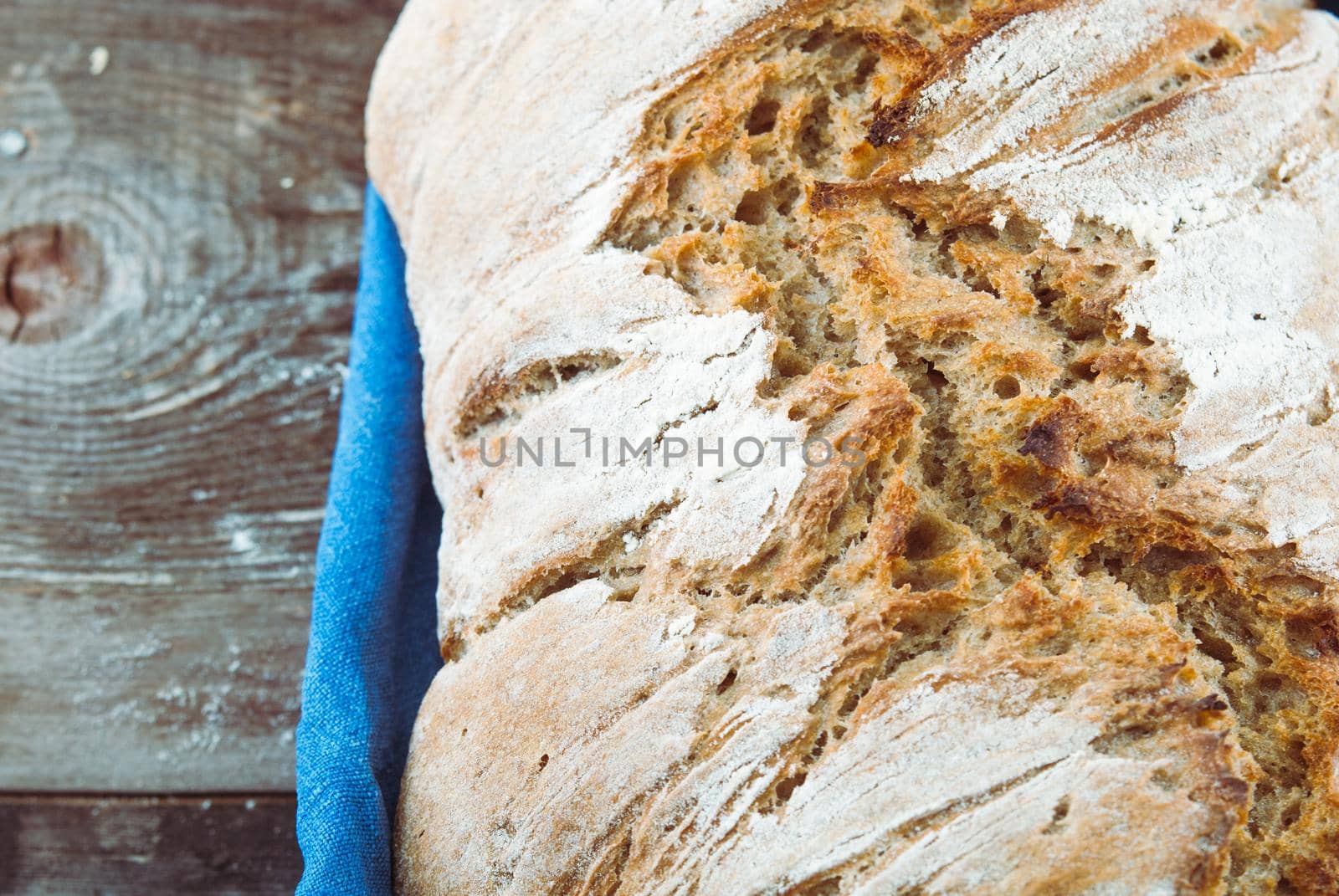 wholegrain fresh homamade bread on wooden roostick background