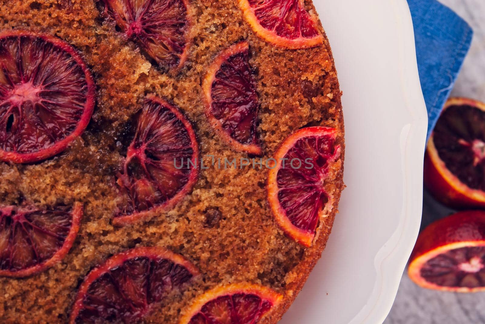 delicious cake with red oranges slices on top. High quality photo